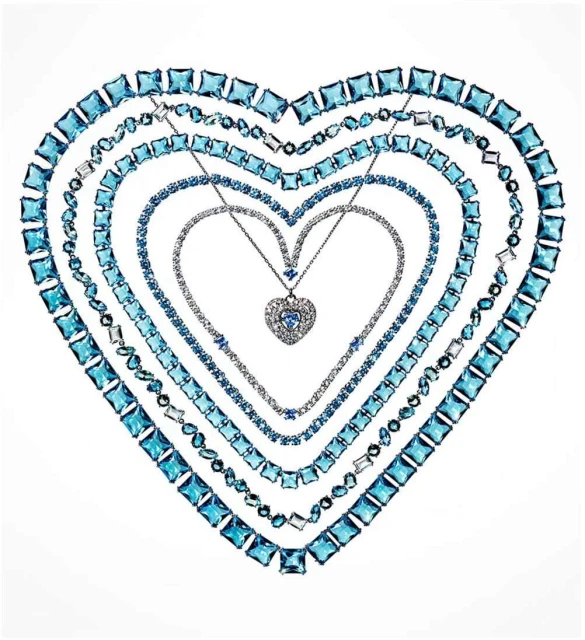 Necklaces with blue and white gemstones arranged in a heart shape against a white background, creating a visually appealing composition.