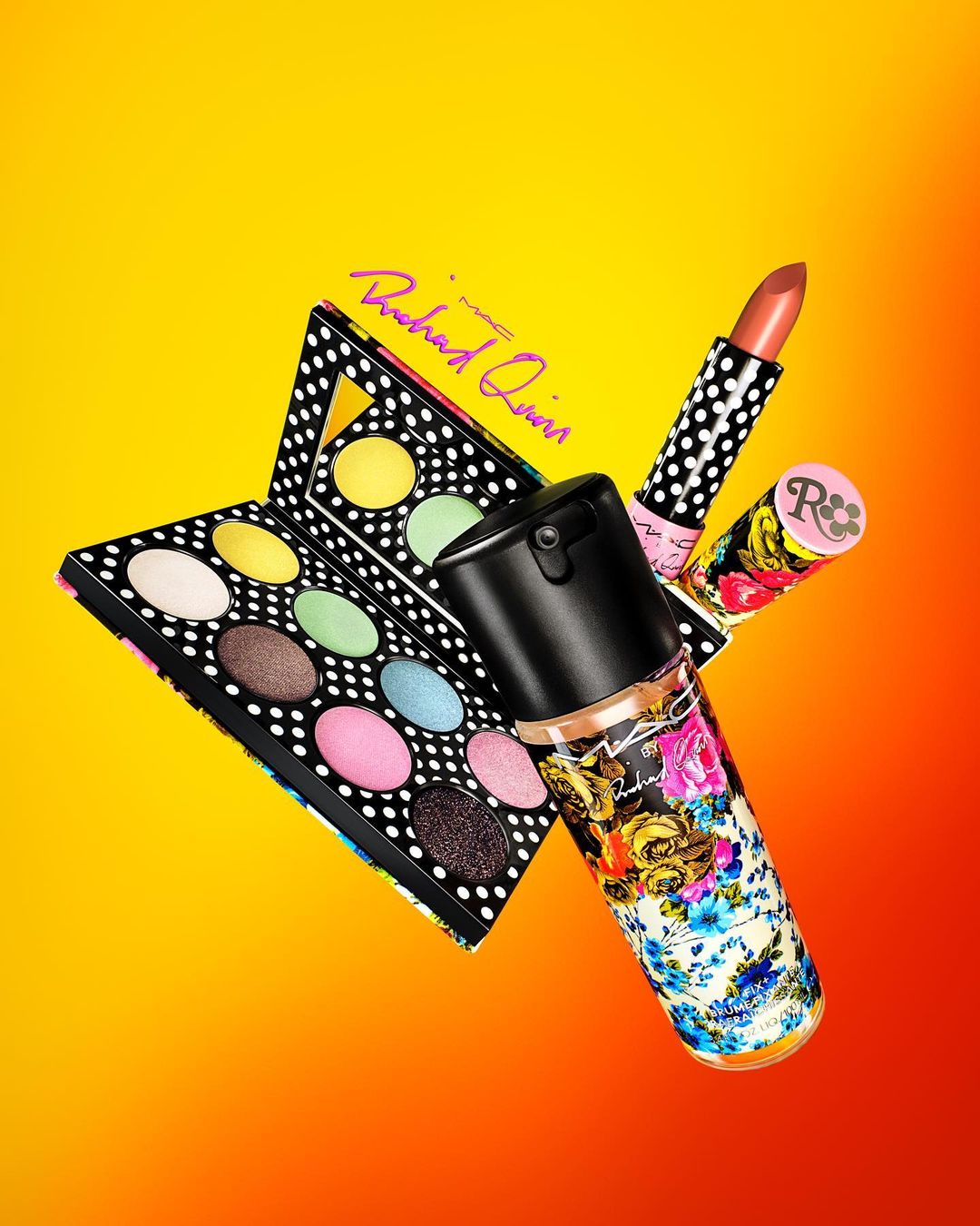 Still life shot of makeup products: eyeshadow palette, lipstick and a floral bottle, against a yellow and orange gradient background.