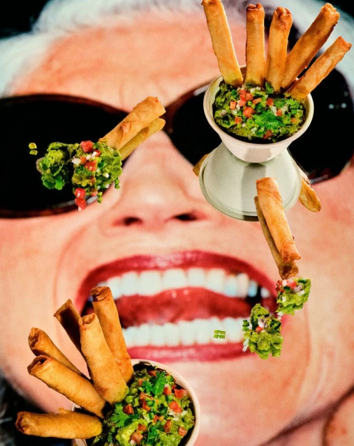 Overhead shot of taquitos and guacamole arranged in a surreal pattern over an image of a woman's face and teeth.