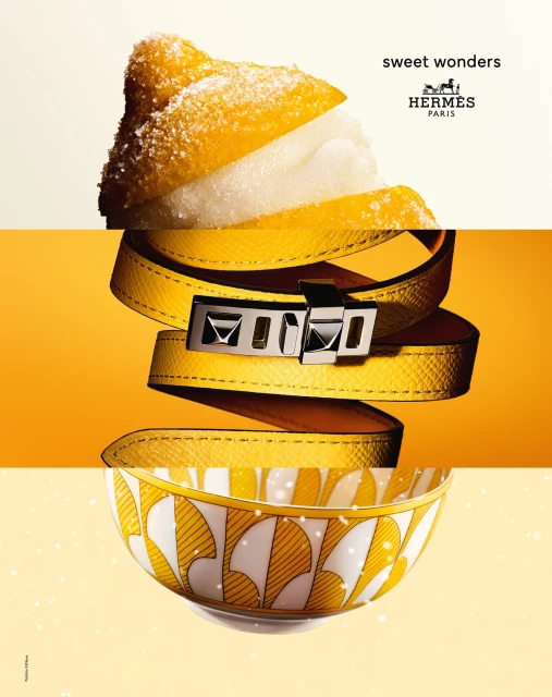 Hermes brand advertisement featuring a deconstructed image of a sugared pastry, a leather belt, and a decorative bowl on yellow background.