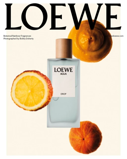 Loewe Agua perfume bottle with orange slices on a beige background, fashion beauty advertisement, luxury fragrance, studio shot.