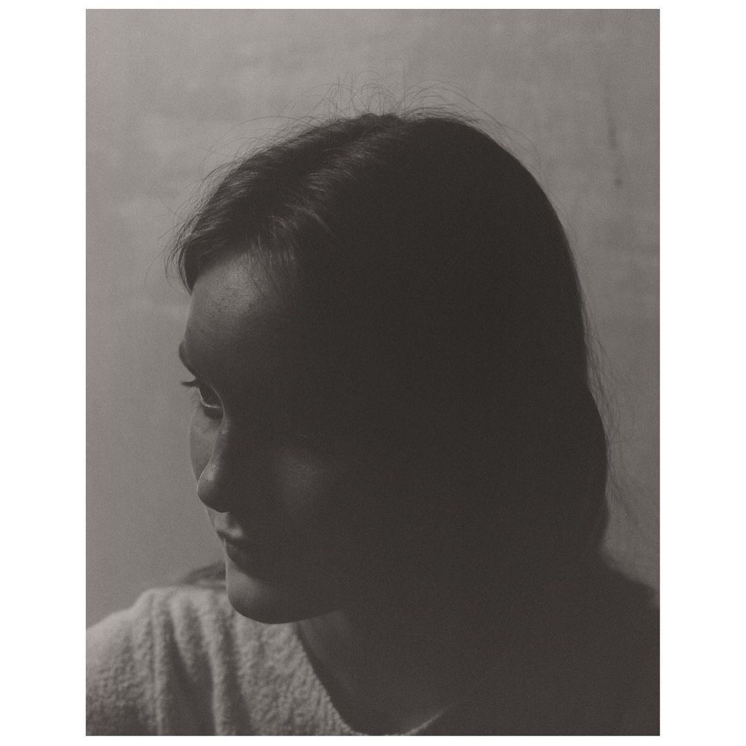 Portrait of a woman with dark hair in profile shot by photographer Boe Marion in New York.