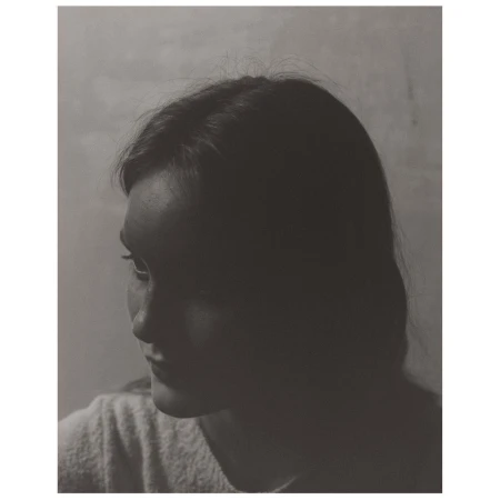 Portrait of a woman with dark hair in profile shot by photographer Boe Marion in New York.