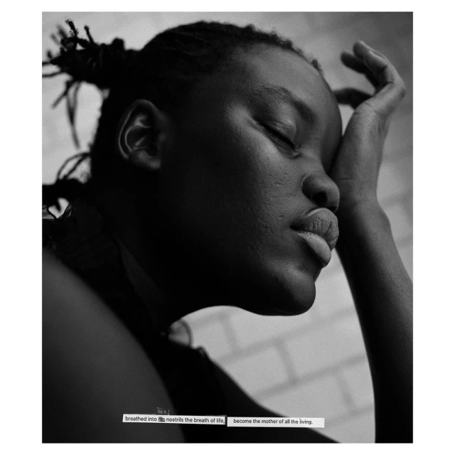 Monochromatic portrait of a Black woman with a hand near her face, eyes closed, and hair styled in small buns, against a neutral background.
