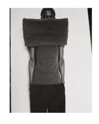 Black man wearing a large knitted grey roll-neck sweater held up to his nose by Boe Marion