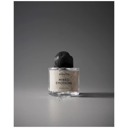 Studio shot of Byredo Mixed Emotions perfume bottle with a black cap on a grey background, beauty and cosmetics product photography.