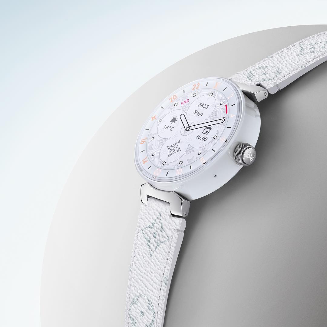 Luxury white smartwatch featuring a Louis Vuitton-patterned band set against a clean, neutral background for a high-fashion aesthetic.
