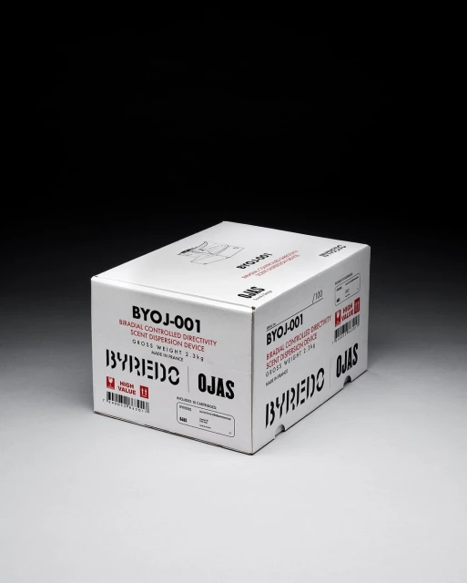 A white cardboard box for a Byredo Ojas radial controlled directivity scent dispersion device, displayed on a neutral surface against a dark background.