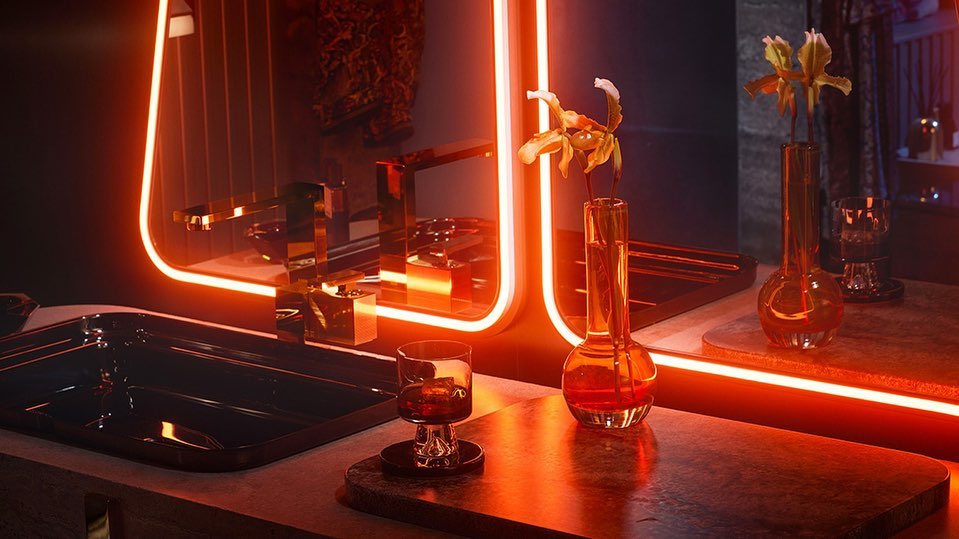 Interior design featuring a modern bathroom with sleek fixtures, orange neon lighting, flowers in glass vases, and a sophisticated aesthetic.