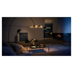 Modern living room interior with a curved brass floor lamp and a low black coffee table photographed by Bohman+sjostrand