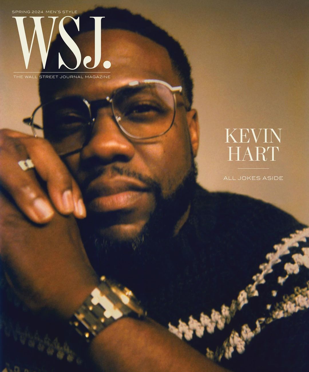 Kevin Hart magazine cover. Close-up portrait of Hart wearing eyeglasses, black sweater, and gold watch with WSJ magazine logo.