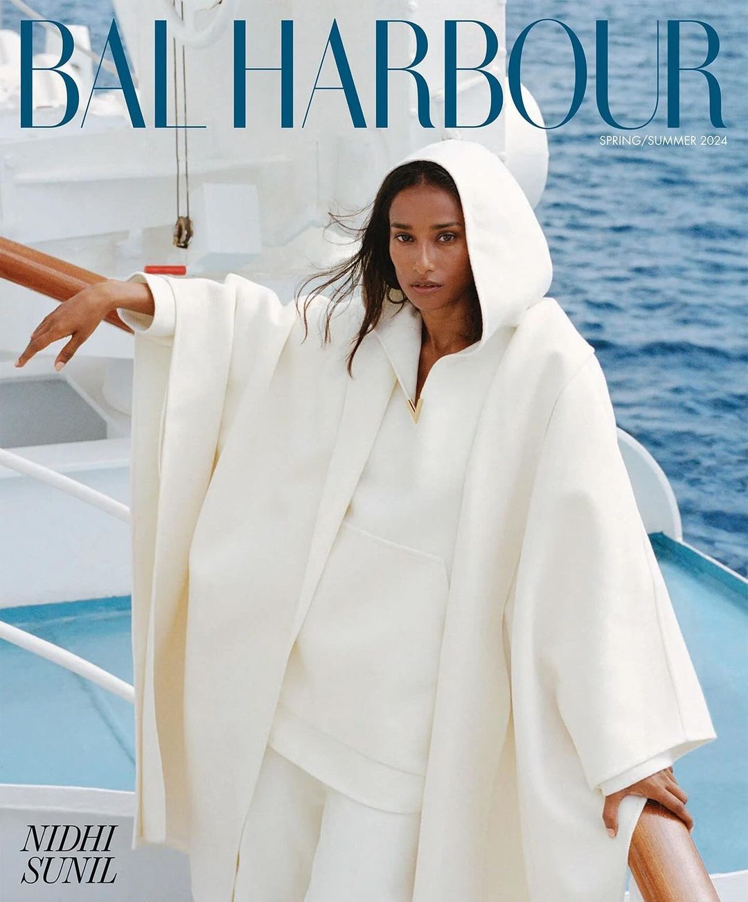 Magazine cover featuring a woman in an all-white hooded outfit on a boat with ocean background, promoting Bal Harbour Spring/Summer 2024.
