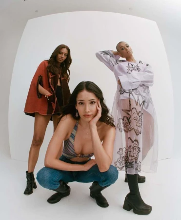 Three female models posing in a white studio setting shot with a wide-angle lens by photographer Brad Ogbonna.