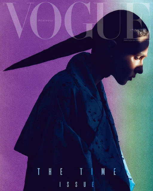 Vogue Portugal magazine cover featuring a model in profile with a long ponytail, shot in a photo studio with colored gel lighting.