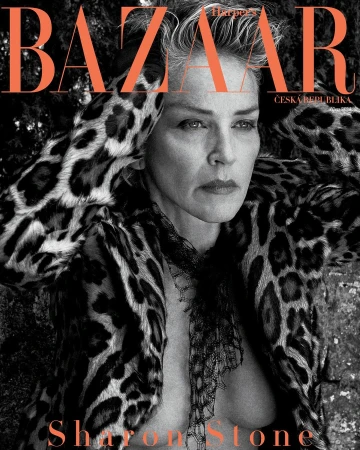 Sharon Stone poses for Harper's Bazaar cover, wearing an animal print coat and sheer scarf, shot outdoors with soft, diffused light.