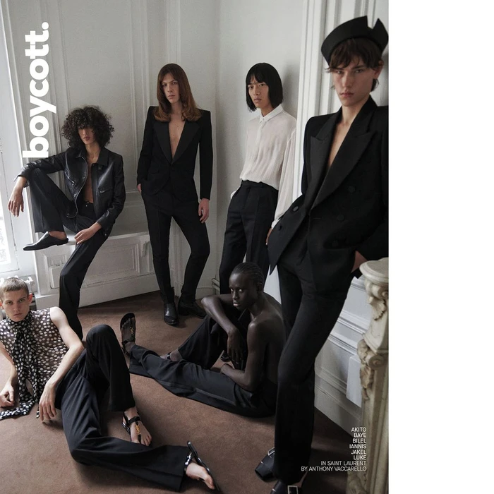 Group of six fashion models in black suits and tailored attire posing in a Parisian interior by Branislav Simoncik