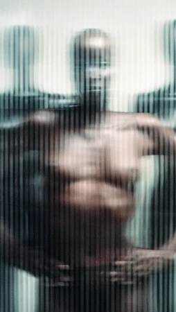 Distorted view of a group of figures in front of a vertically striped background, using blurred focus and strong contrasts.