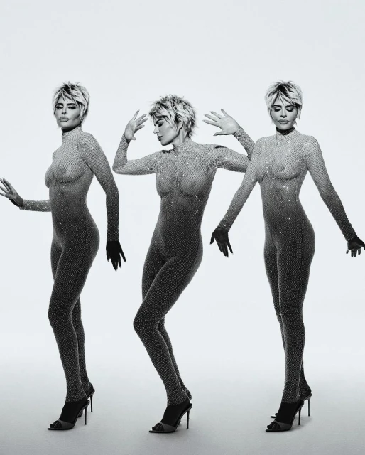 Three adult women posing in sheer catsuits and high heels on a white background, showcasing a mirrored, monochromatic fashion shot.