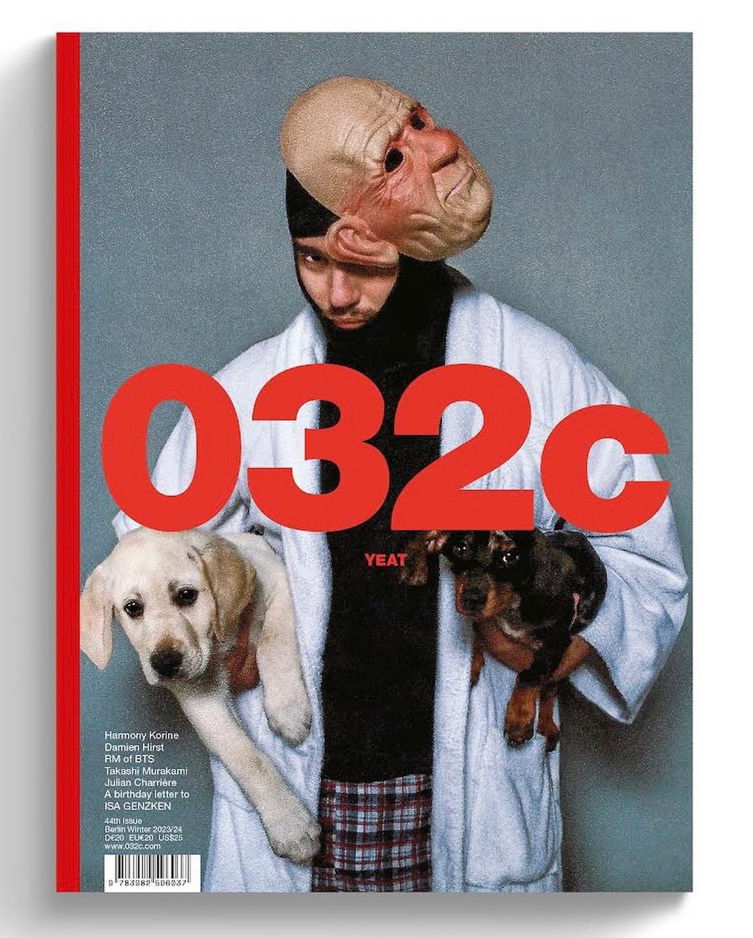 Magazine cover featuring a person with a mask, two puppies, and the text '032c YEAT' in red on a light grey background.