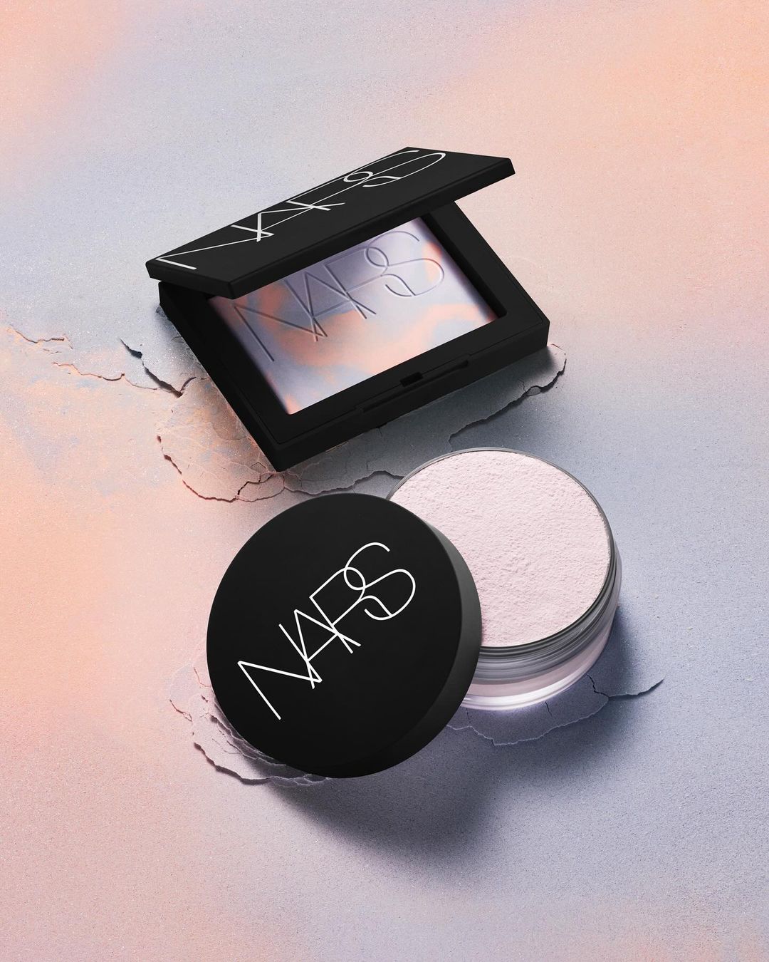 NARS cosmetics still life featuring powder and bronzer compacts on a textured surface, in a studio setting with soft lighting.