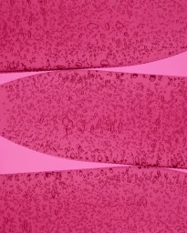 Macro shot of vibrant pink viscous gel with suspended air bubbles layered against a solid pink background.