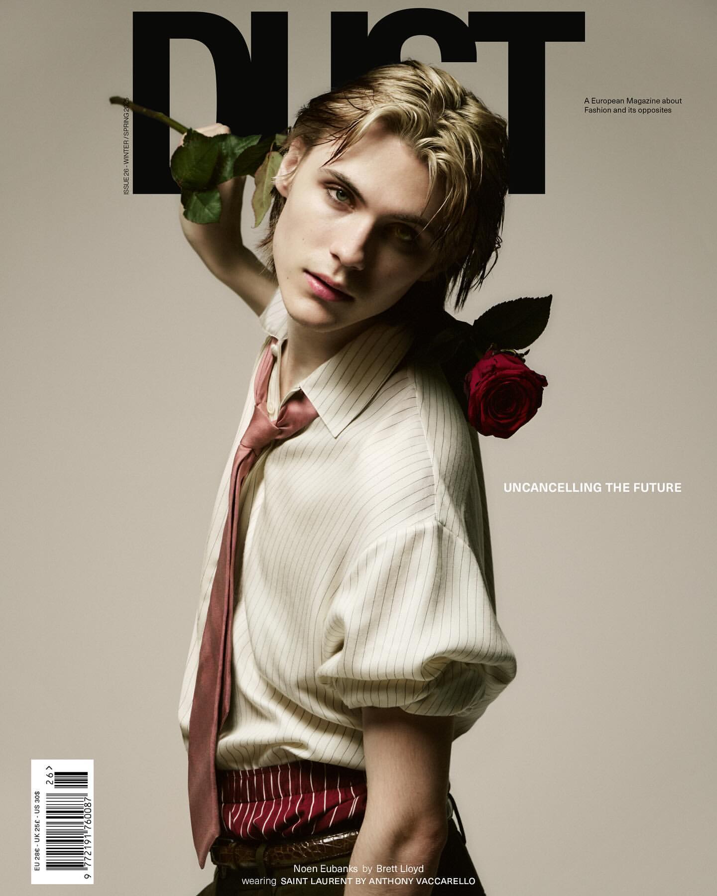 Dust magazine cover featuring a young adult male with blond hair, wearing striped shirt and tie, holding red roses against a light background.