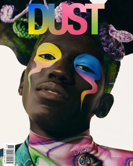 Magazine cover featuring a person with colorful face paint and decorative yarn, wearing a patterned top with a 'DIOR' logo.
