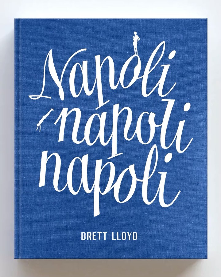 Close-up of the cover of the book Napoli 'napoli napoli' by Brett Lloyd, featuring white calligraphic text on a blue textured background.
