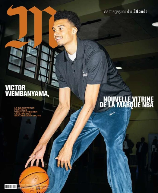 Magazine cover featuring basketball player Victor Wembanyama dribbling a basketball, with a focus on his athletic stance and smiling expression.