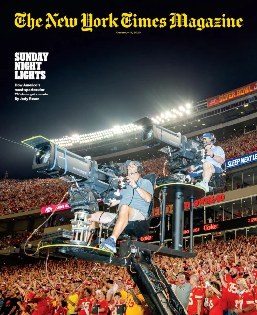 New York Times Magazine cover featuring two cameramen operating large television cameras at a stadium event with a cheering crowd.