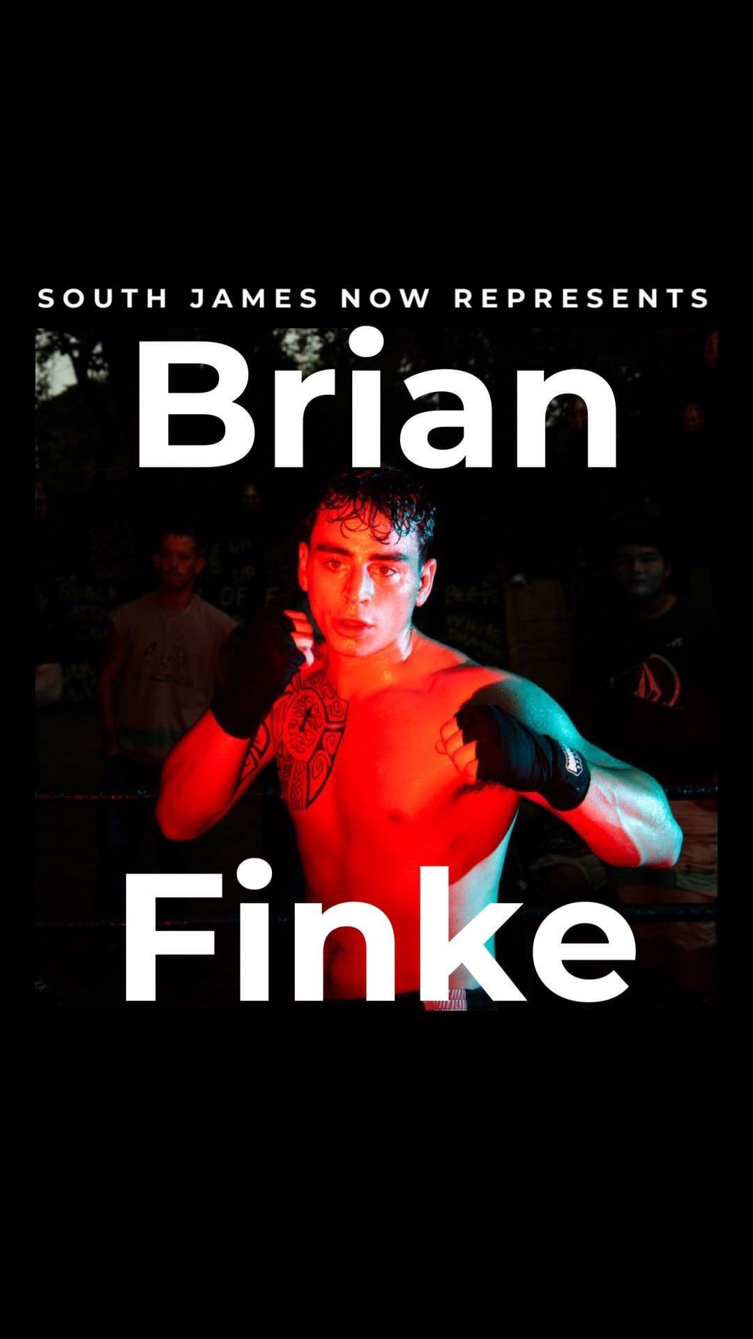 A shirtless boxer with tattoos wearing black boxing gloves stands center frame. A spotlight illuminates the athlete in an outdoor boxing arena.