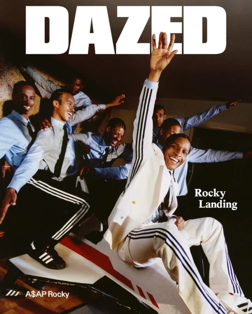 Magazine cover shot with ASAP Rocky in a white Adidas tracksuit, sitting on a toy rocket with a group of men behind him.