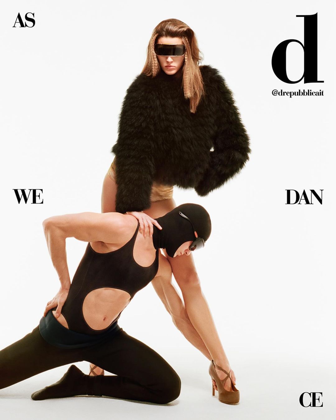 Two models pose in a studio. One wears a fur coat, while the other in a black bodysuit with cut-outs and a balaclava.