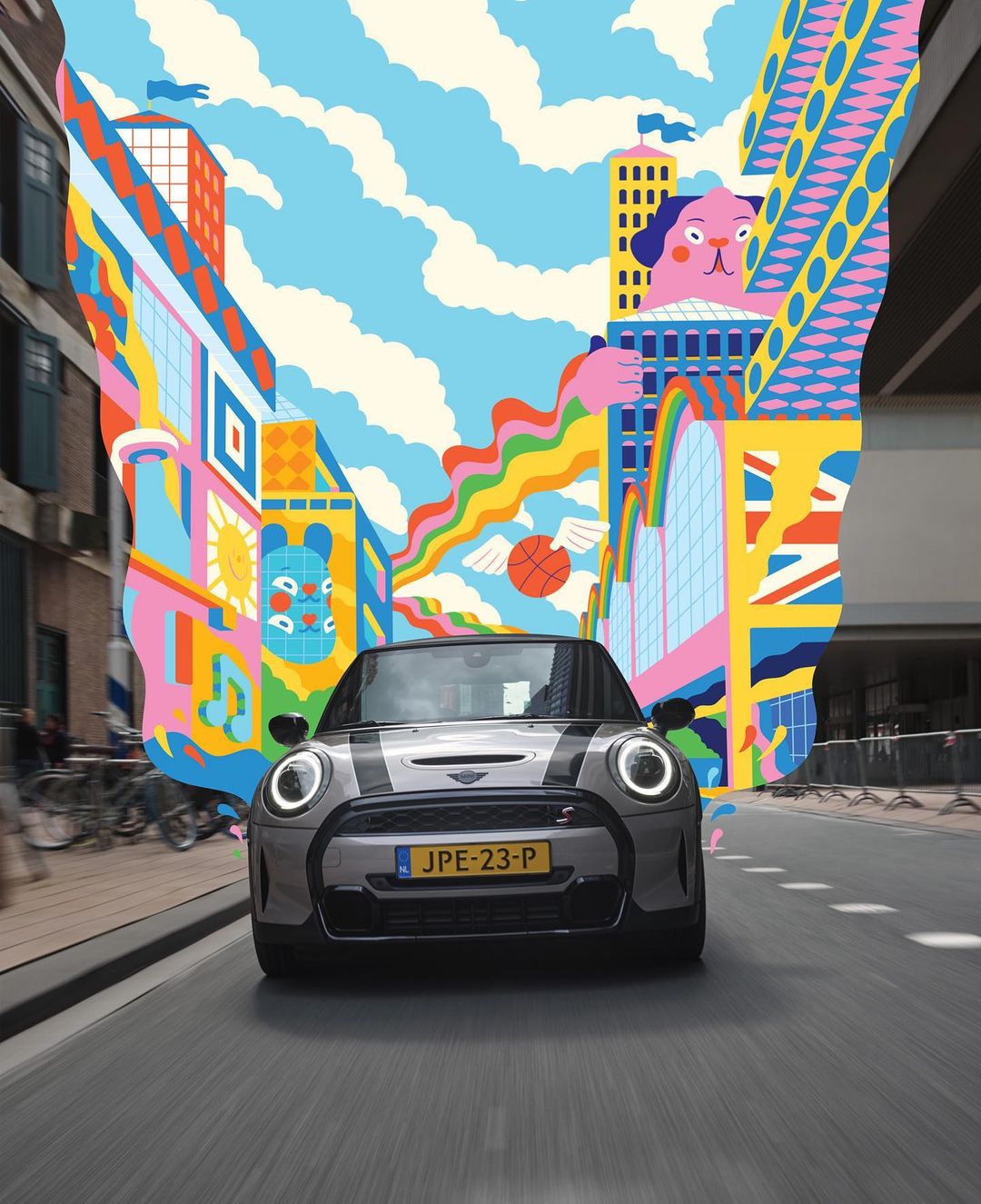 Gray Mini Cooper car driving on an urban road with a colorful abstract cityscape illustration, blending reality and artistic fantasy.