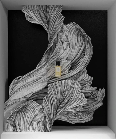 Close-up product shot of a perfume bottle with black lid. The bottle is placed in front of an abstract swirling black and white pattern.