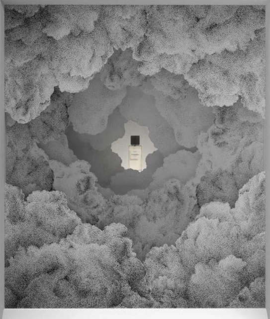 Perfume bottle surrounded by clouds in a monochrome studio shot. The focus is on the bottle, set against an abstract, dreamy cloudscape.