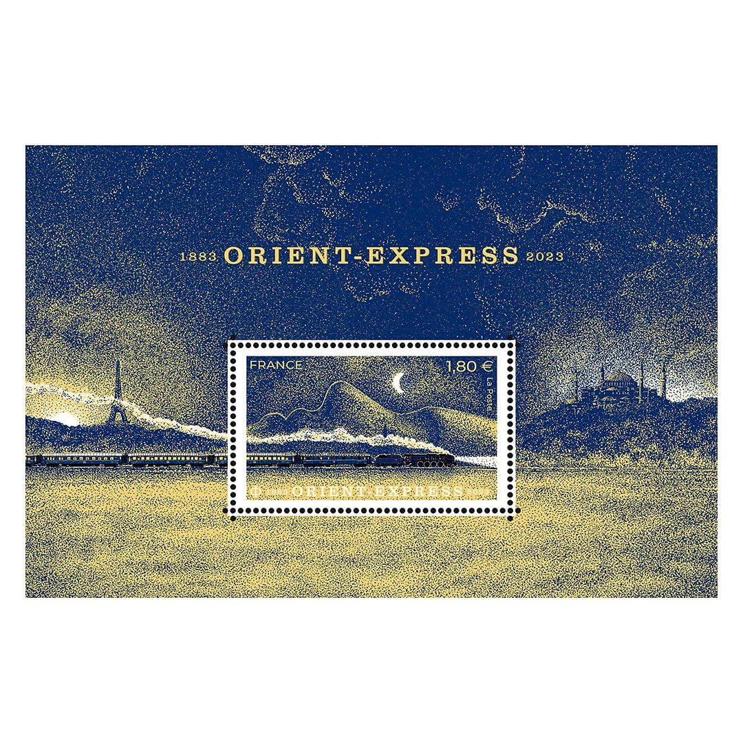 Illustration of the Orient Express train against a stylized landscape featuring the Eiffel Tower and mountains on a postage stamp.