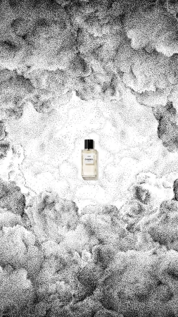 Artistic product shot: a perfume bottle stands against a stippled monochrome backdrop that mimics clouds and a celestial sky.