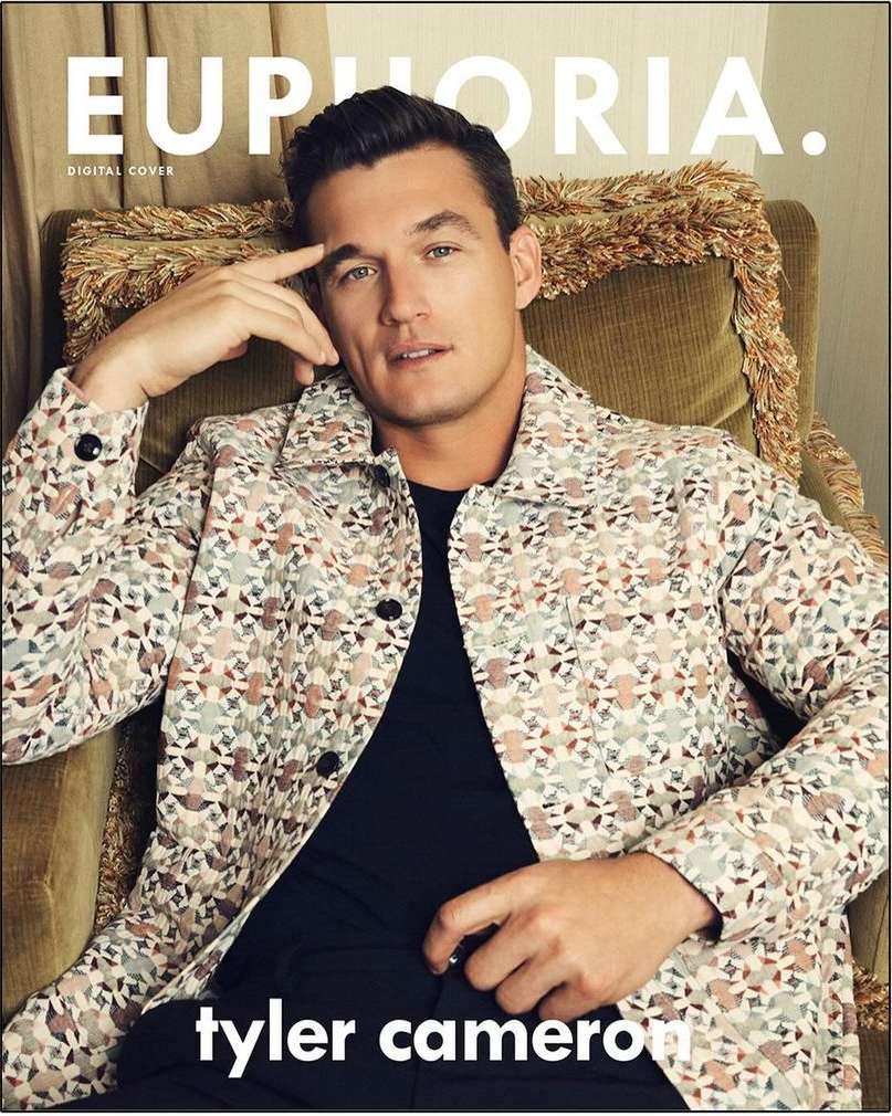 Tyler Cameron on the cover of Euphoria magazine, wearing a patterned jacket and sitting in a green chair with gold trim.