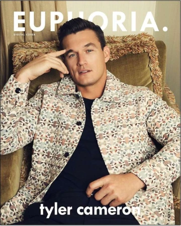 Tyler Cameron on the cover of Euphoria magazine, wearing a patterned jacket and sitting in a green chair with gold trim.