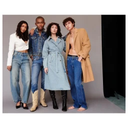 Four diverse models posing in denim and outerwear against a neutral grey studio backdrop by photographer Bryan Solarski.
