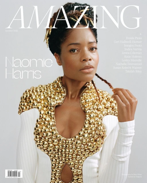 Magazine cover featuring Naomi Harris, wearing a white dress with gold embellishments, in front of a light grey background with text.