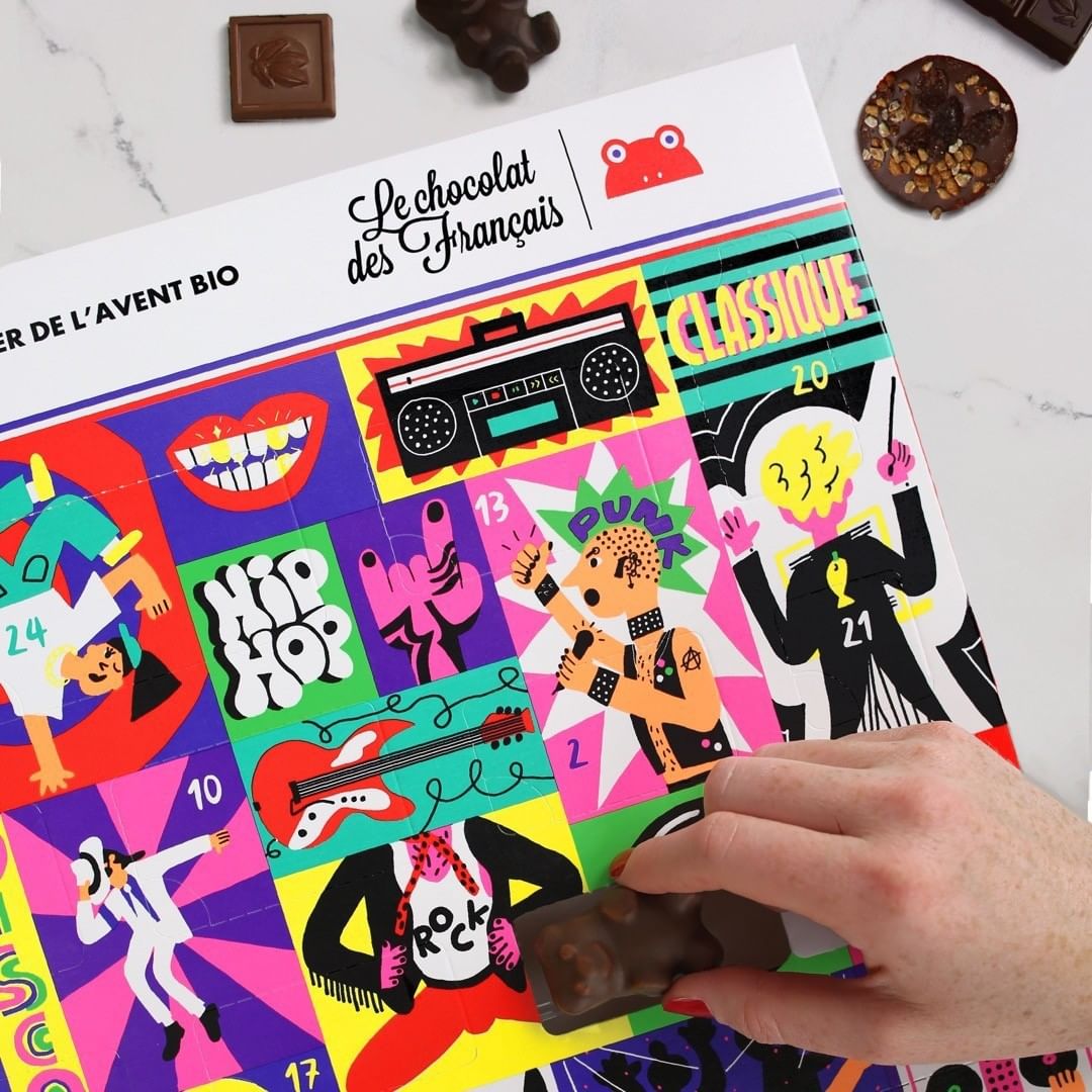 Chocolate advent calendar featuring colorful pop-art-style graphics of music genres and a hand holding a chocolate piece.
