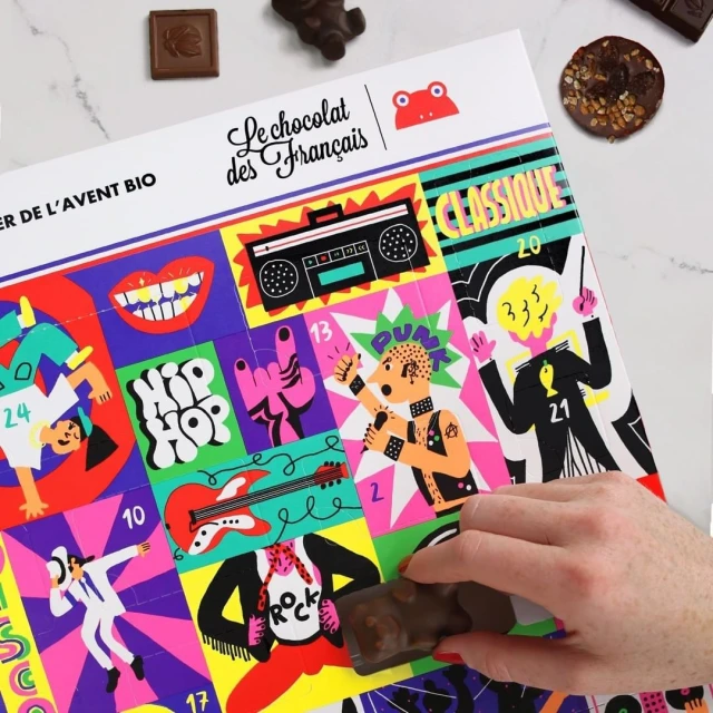Chocolate advent calendar featuring colorful pop-art-style graphics of music genres and a hand holding a chocolate piece.
