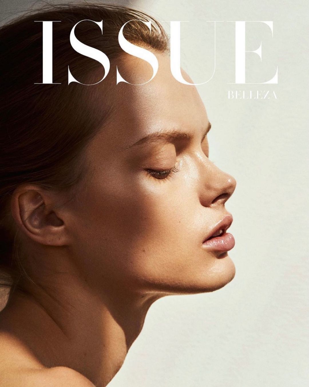 Close-up profile portrait of an adult woman with fair skin, featuring bright natural light, and the text 'ISSUE BELLEZA' on the magazine cover.