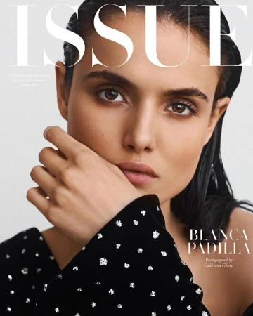 Close-up portrait of Blanca Padilla with wet-look dark hair wearing a black rhinestone-embellished top by photographer Caleb and Gladys.