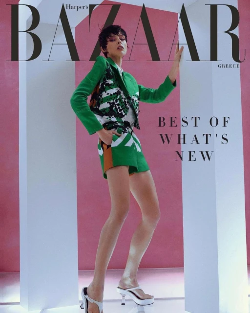 Fashion editorial cover of Harper's Bazaar Greece featuring model in a green patterned suit, posing in front of pink and white columns.