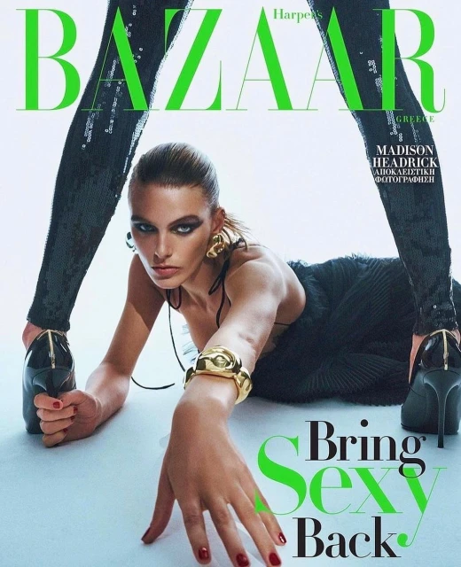 Fashion magazine cover featuring a model in a black dress with gold jewelry, posing against a white background with bold green typography.