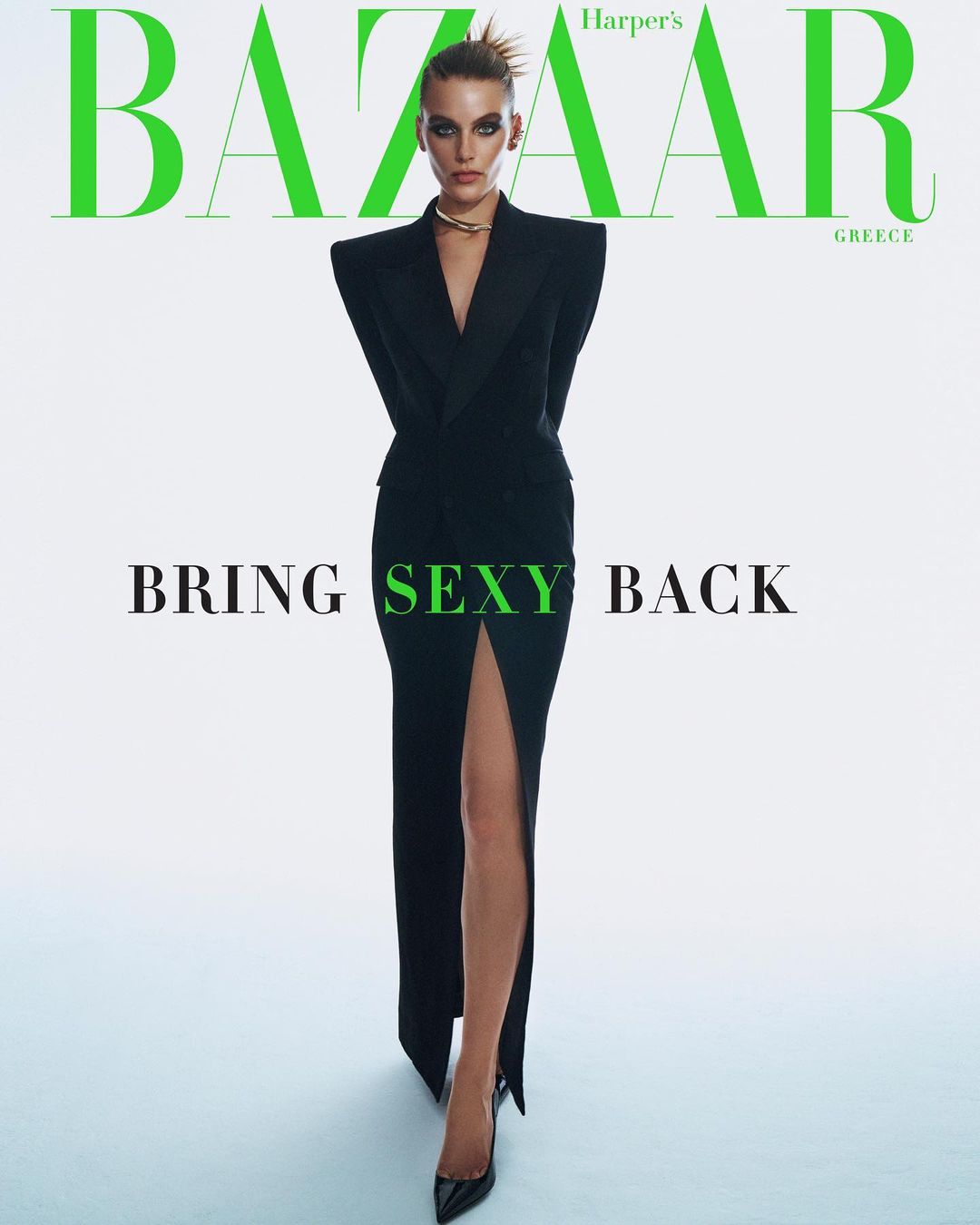 Harper's Bazaar Greece cover featuring a fashion model in a black dress with a high slit, posing against a clean white backdrop.