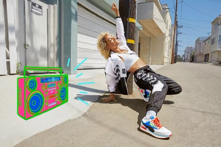 Young woman in athletic wear strikes dynamic pose near a pink boombox in an urban outdoor setting, showcasing vibrant energy.